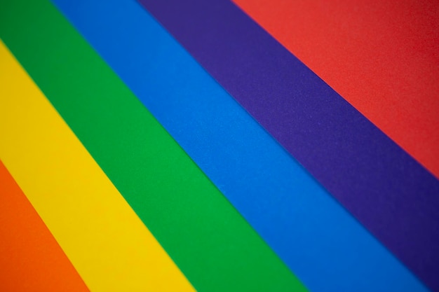 The background texture of colored paper is distributed in the color spectrum like a rainbow