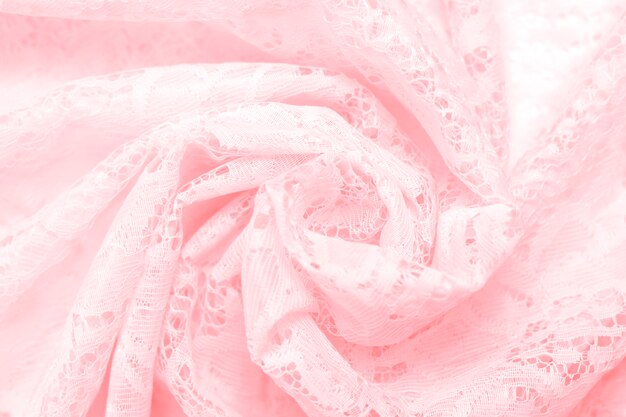 Background texture of delicate lace fabric of pink color 