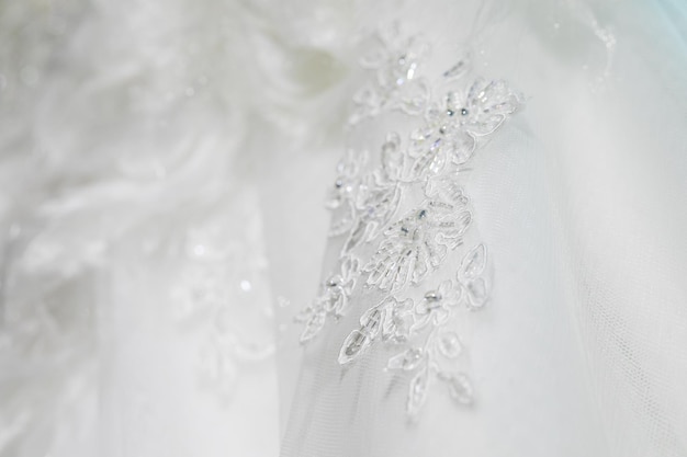 Background, texture, embroidered lace. Delicate detail of a wedding dress