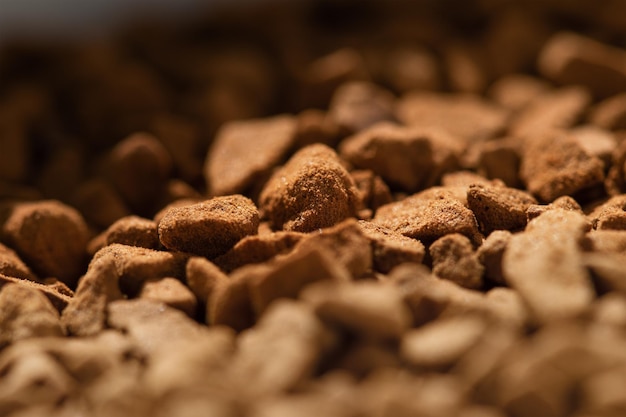 Background texture of freeze dried instant coffe granules high magnification macro photo selective focus