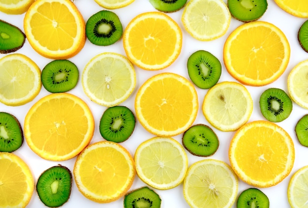 Background texture-fruit mix: lemon, orange, kiwi on white background. Close-Up. Isolated.