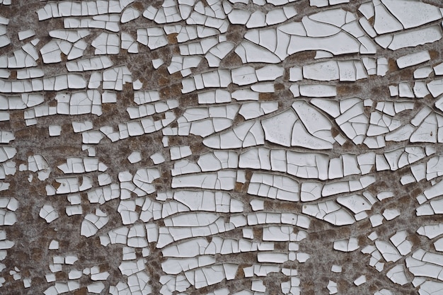 Background texture. Gray surface with white old cracked paint. Top view, copy space