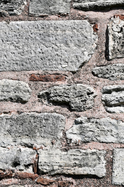 Background texture of natural stone Fragment of an old wall made of large stone blocks