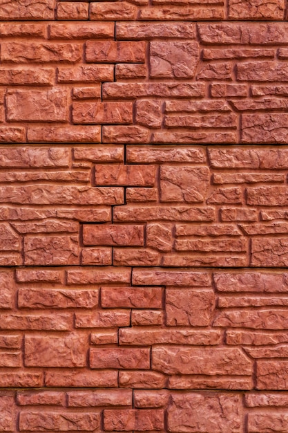 Background texture red stone brick wall with of bricks of different sizes