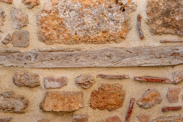 Background texture  rough masonry from wild stone and cement on a wooden frame