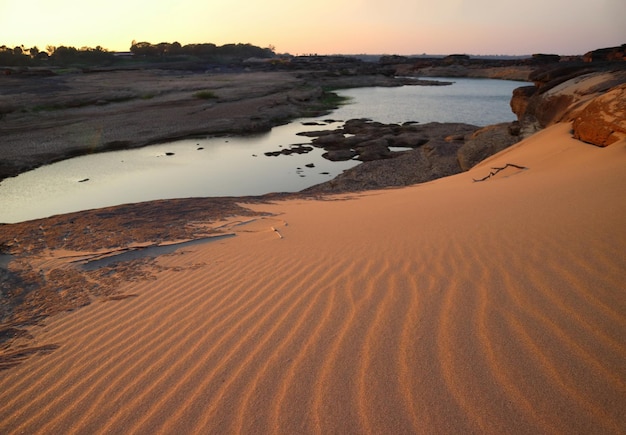 Background and texture of sand pattern at a riverside in the summer.