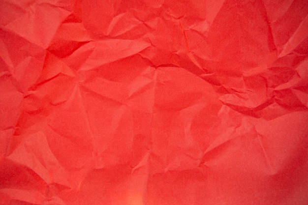 Background texture of a sheet of red crumpled paper.