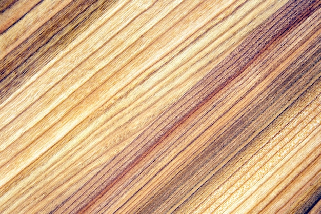 Background and texture of smooth treated wood close-up diagonally.