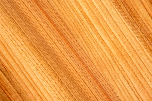 Background and texture of smooth treated wood close-up diagonally.