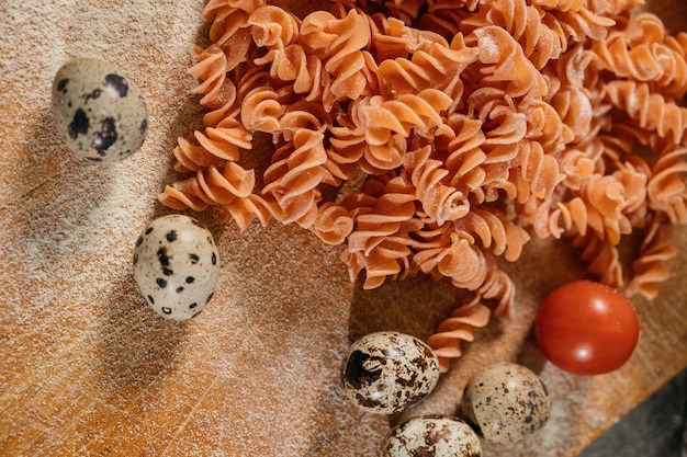 Background texture of tricolor fusilli pasta for traditional Italian and Mediterranean cuisine in a close up full frame view. High quality photo