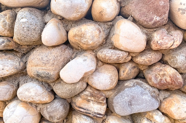 Background, texture, wall of round natural stone.