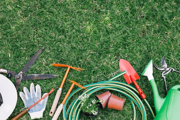 Background of tools on green grass in garden