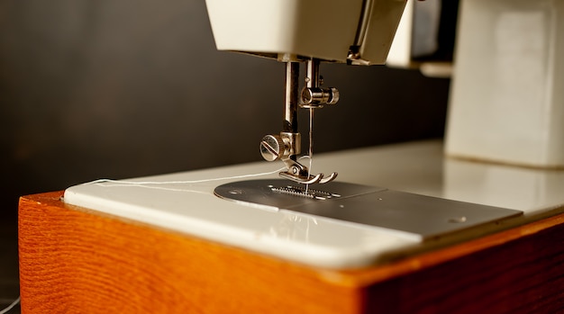 Background type of sewing machine, leather belt sewing process. Leather workshop.