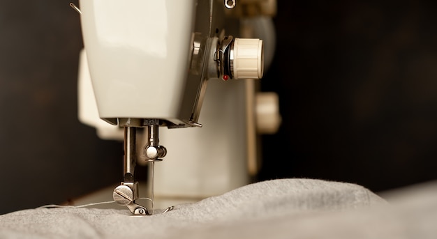 Background type of sewing machine, leather belt sewing process. Leather workshop.