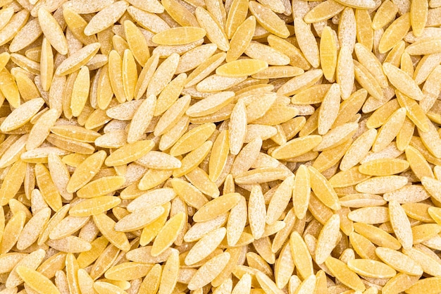 Background uncooked orzo risoni pasta