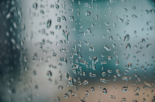 Background and wallpaper by rainy drop and water drops on window glass.