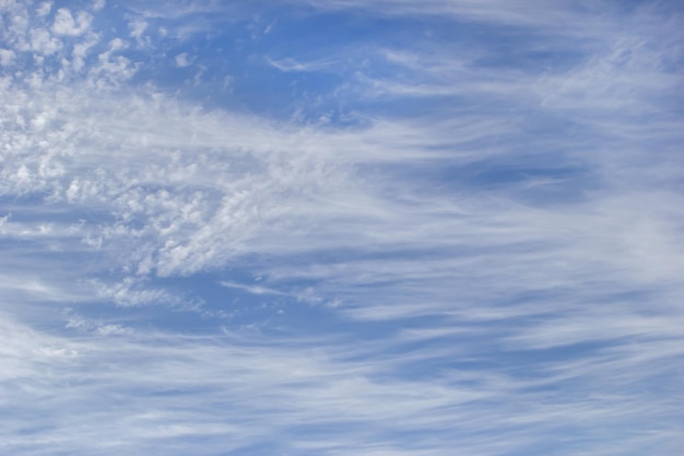 Background white cirrus clouds on the background blue sky