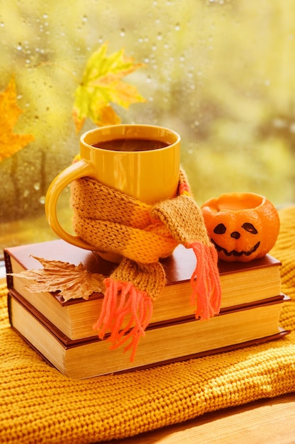 Background with books cup of tea pumpkin