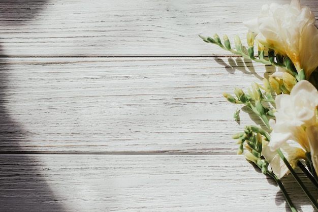 Background with a bouquet of flowers on white wooden boards