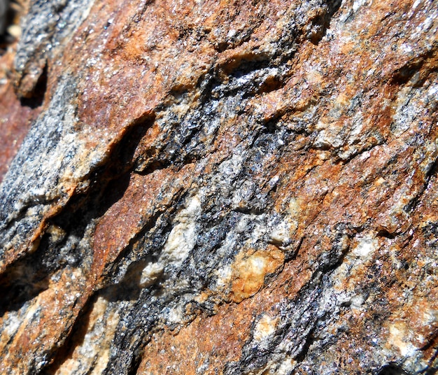 background with bright red stone wall with very deep cut and close up