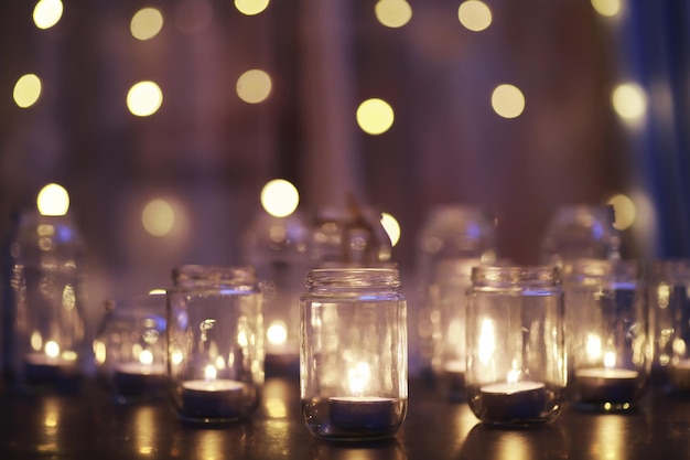 Background with candles in glass vessels candles burn in a dark\
place rest in peace