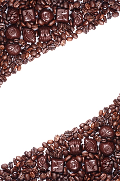 Background with chocolate candy and coffee beans on white