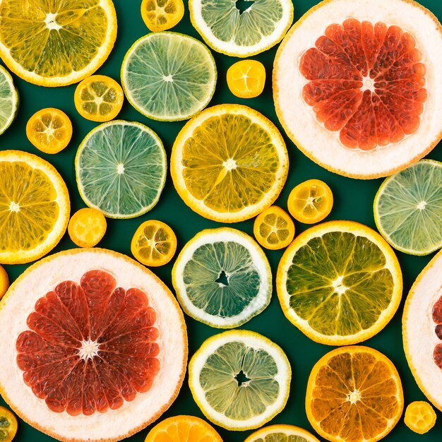 Background with citrus fruit circle slices - orange, tangerine, lime, grapefruit on green background.