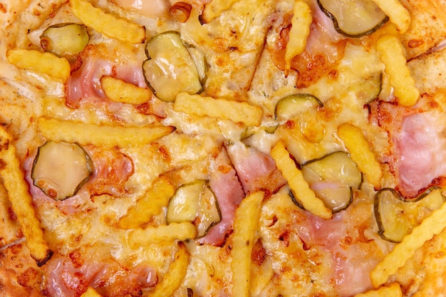 Background with closeup pizza with bacon cucumbers fries and cheese