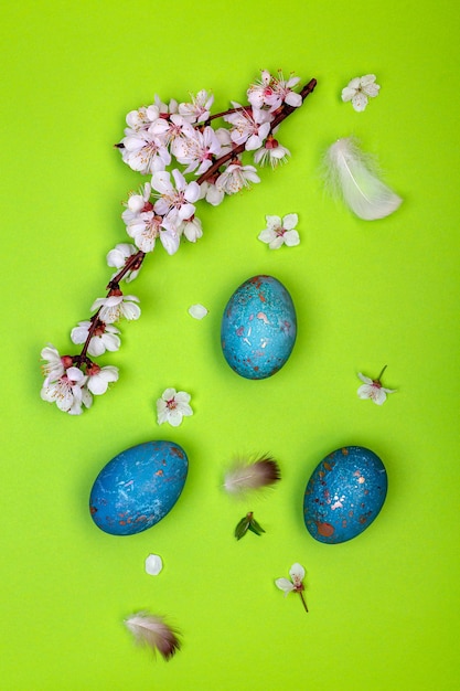 Background with Easter eggs and a flowering branch