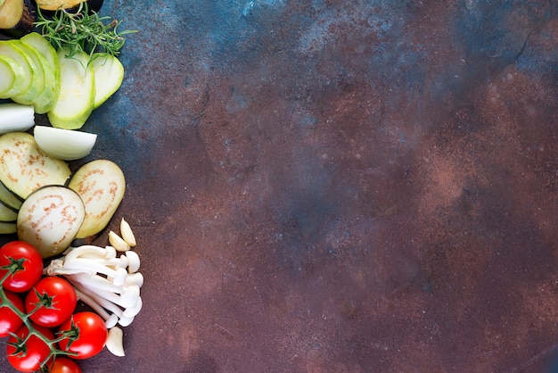 Background with fresh healthy vegetables on stone dark background, flat lay copyspace