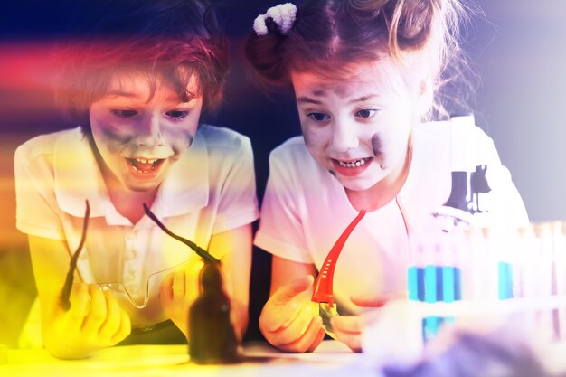 Background with highlights of children of scientists A boy and a girl are experimenting in the laboratory