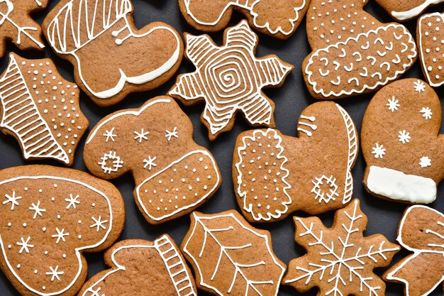 Background with homemade christmas gingerbread cookies on black.