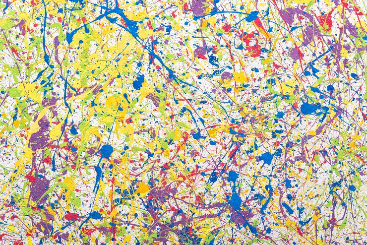 Background with multi-colored splashes of paint on the wall. Colored.