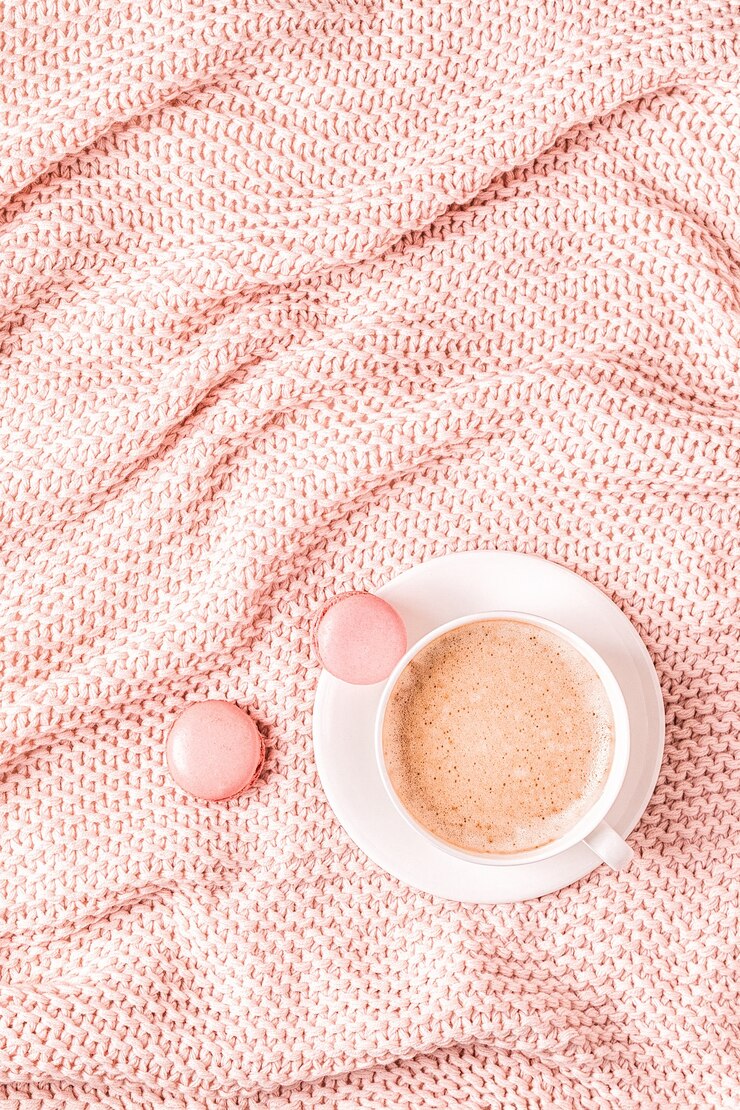 Background with pink plaid, coffee and macaroons, top view, copy space, flat lay.