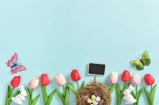 Background with rabbit ears Easter eggs and tulip flowers