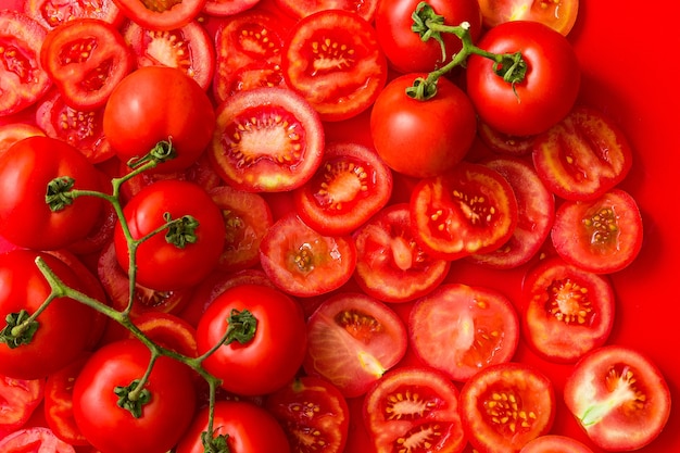 Background with tomato slices and branch