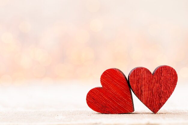 Background with wooden hearts, place for text.