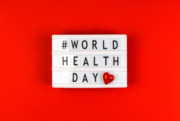 Background with World Health Day text hasgtag on lightbox love theme and charity concept photo