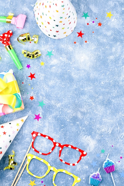 background with wrapped gifts, confetti, party hats, decorations, copy space