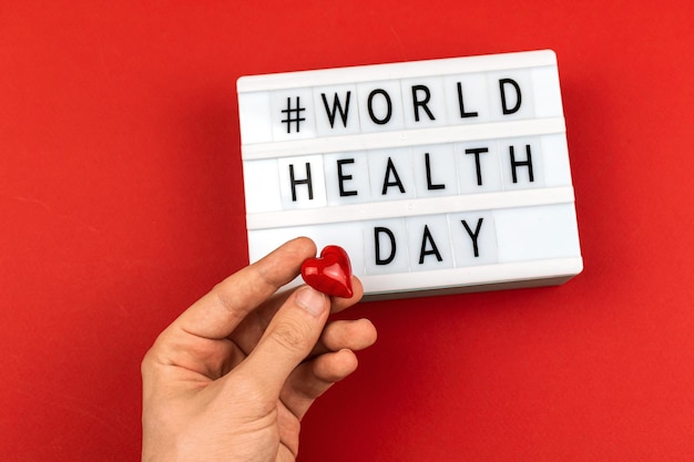 Background for world health day with man hand and red heart healthcare and life insurance concept photo