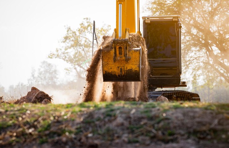 Backhoe working by digging soil at construction site Crawler excavator digging on demolition site