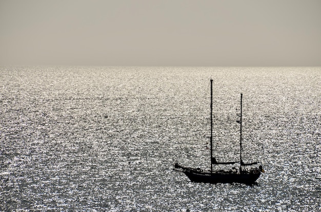 Backlight Picture of a Silhouette Boat in the Ocean