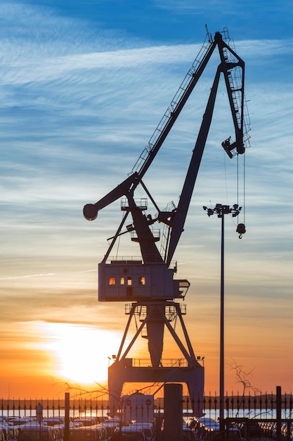 Backlight with a harbor crane at sunrise Puerto de Sagunto Valencia Spain