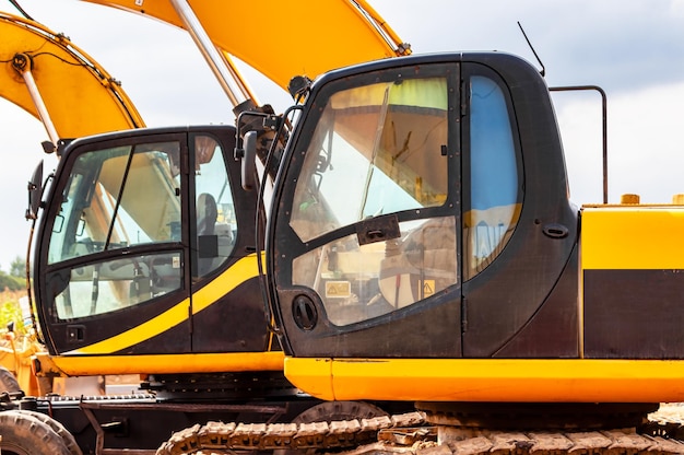 Backlit excavator on an industrial site against the background\
of the evening sky construction machinery for earthworks