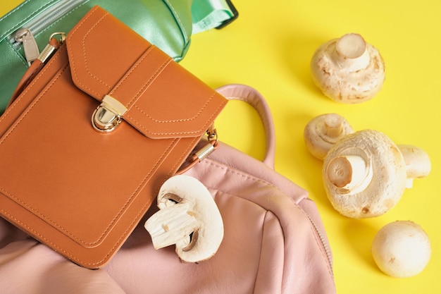 Backpack and bags made of eco leather and champignons on a yellow background, vegan leather from mushroom mycelium concept, innovative materials to replace animal skin