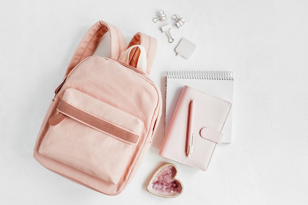 Backpack with school supplies and books for study. Back to school concept. Flat lay, top view