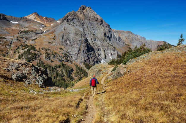 Backpacker in hike in the autumn mountains