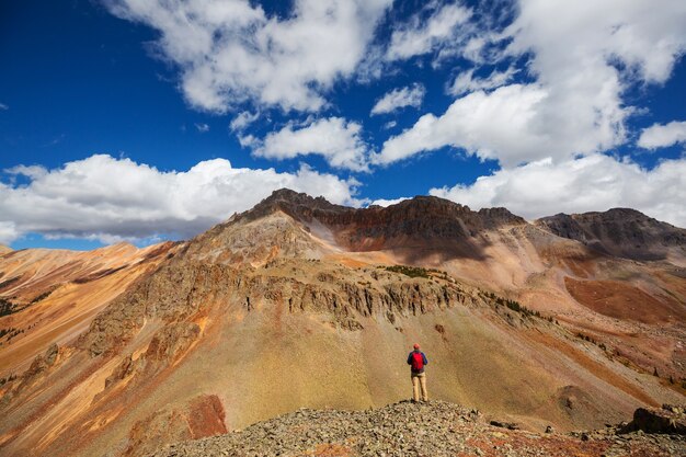 Backpacker in hike in the autumn mountains