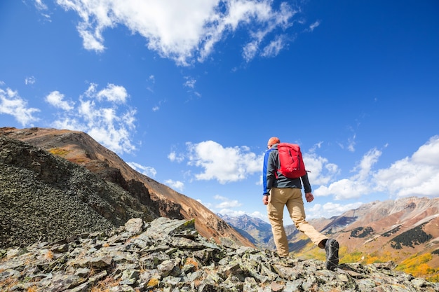 Backpacker in hike in the autumn mountains