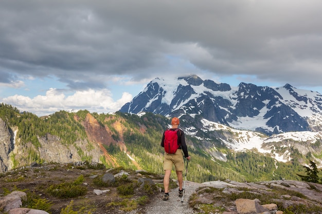 Backpacker in a hike in the summer mountains